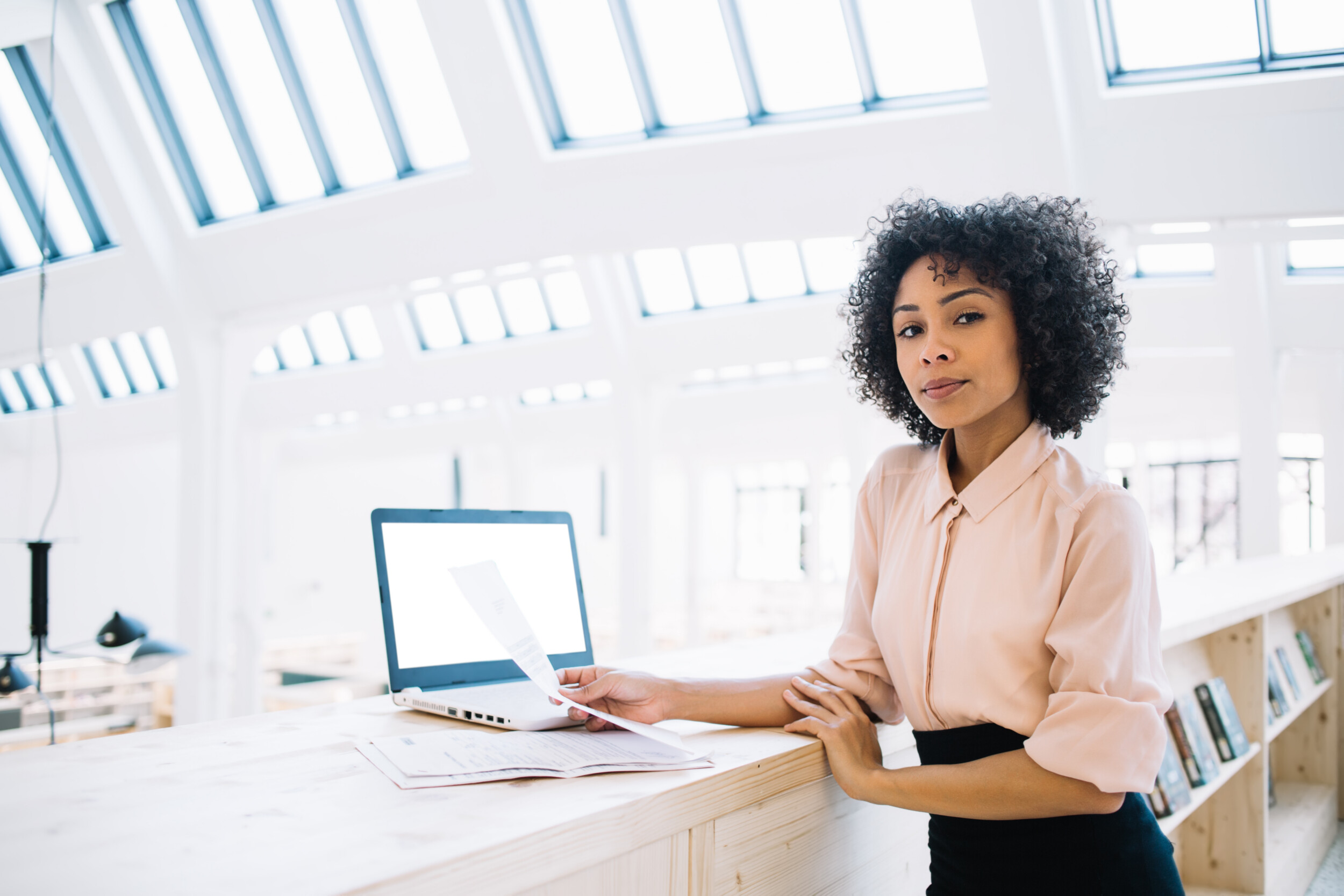 female managing director examining paperwork in of