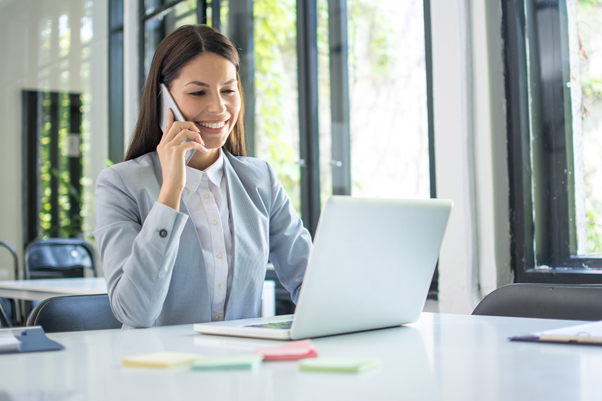 lady working on secure phone and laptop