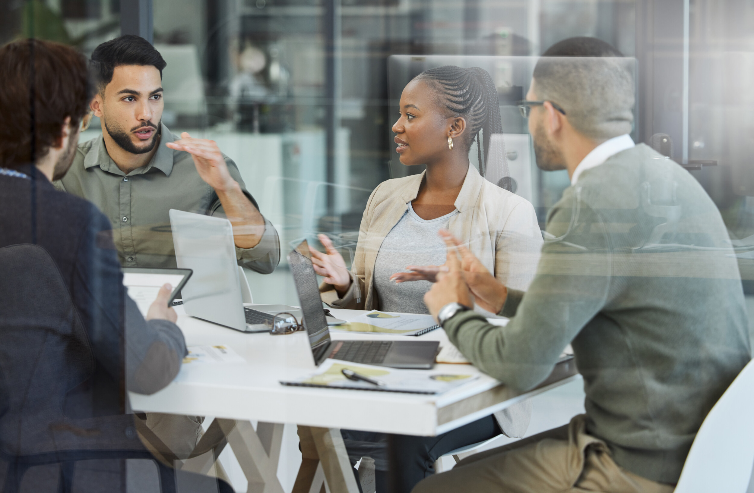 Meeting, collaboration and business people in discussion in the office while working together. Teamwork, planning and group of employees brainstorming with technology for a project in the workplace.