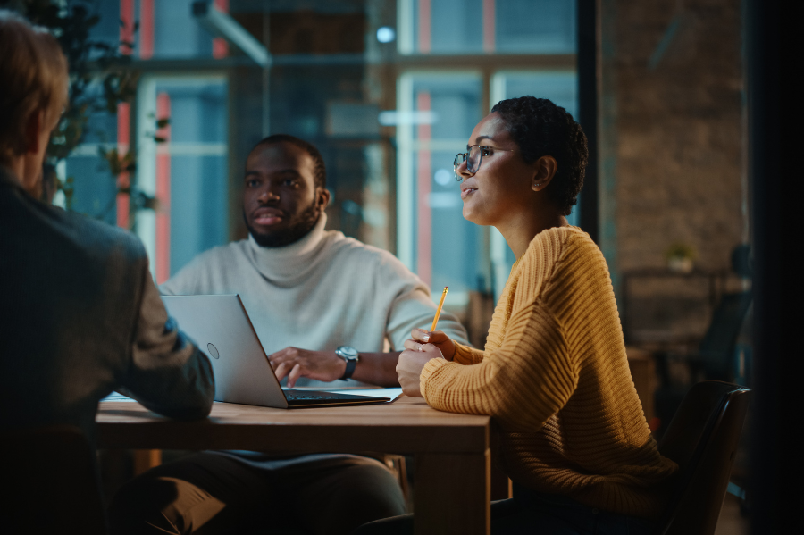 Forta- Young professionals in a meeting room with a laptop