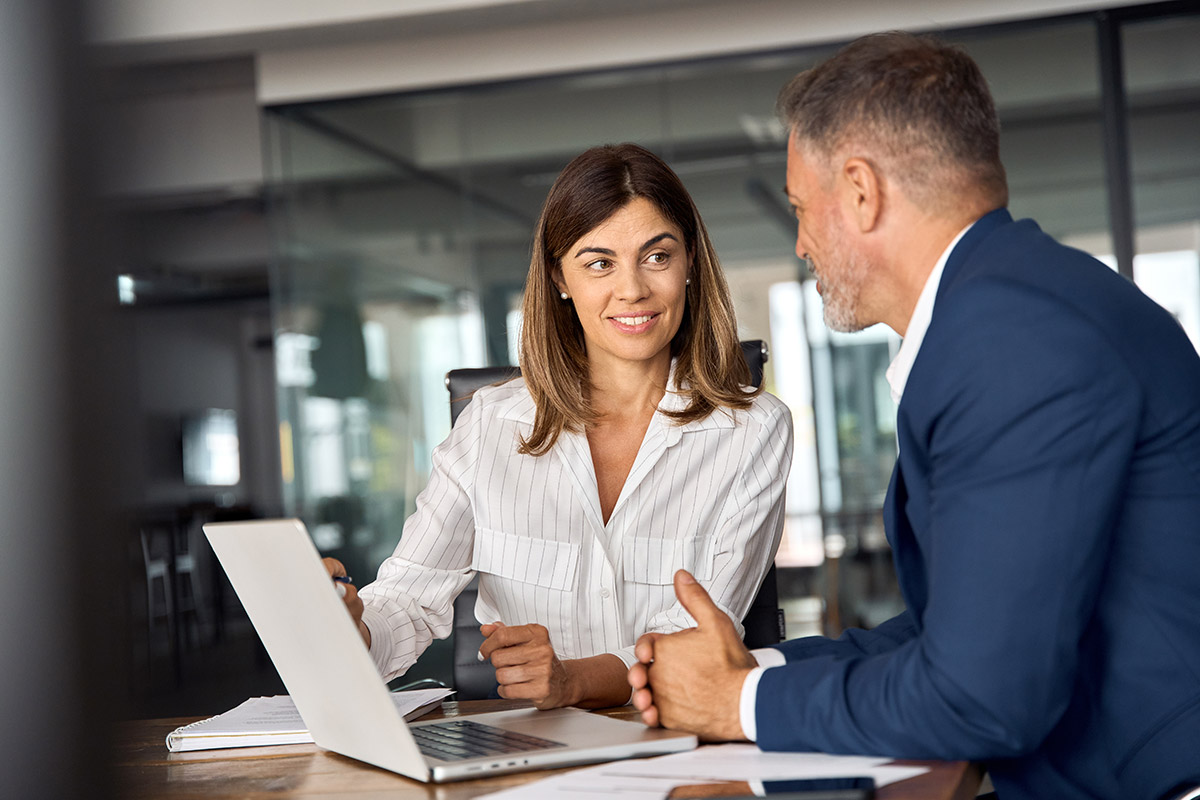 two colleages working togethe on a finance plan