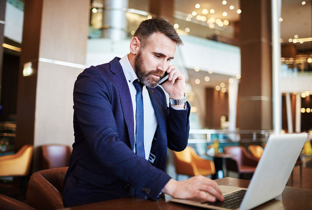 business man working in plublic on computer