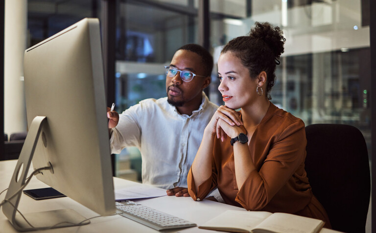 two colleagues working together in technology